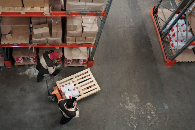 men checking inventory in a warehouse.