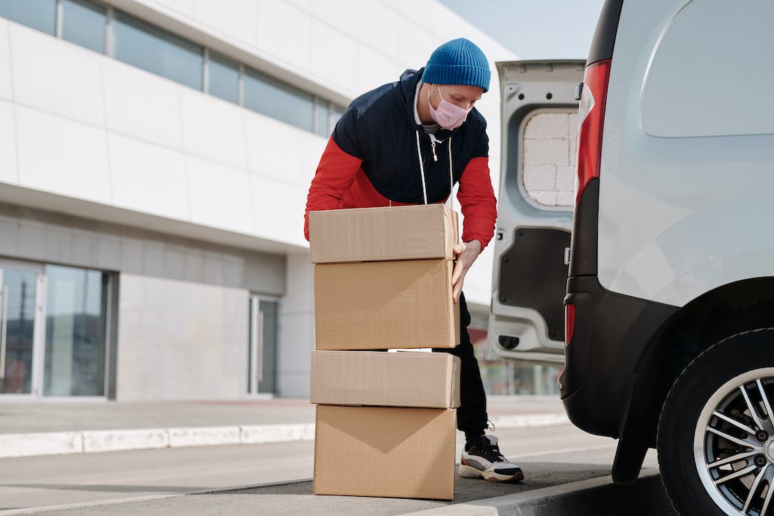 a person loading boxes in a van. 
